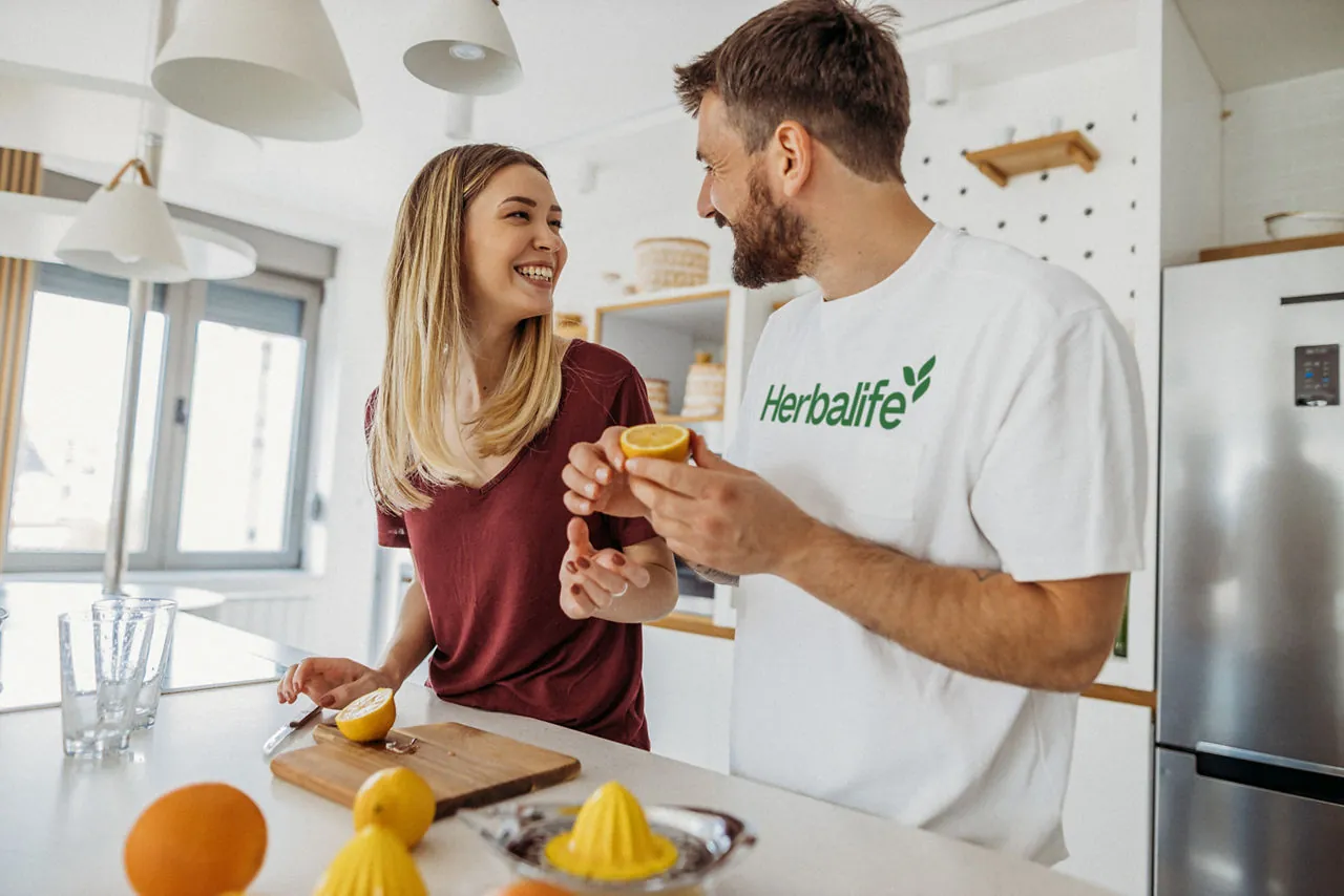 A couple preparing food together in a bright kitchen
